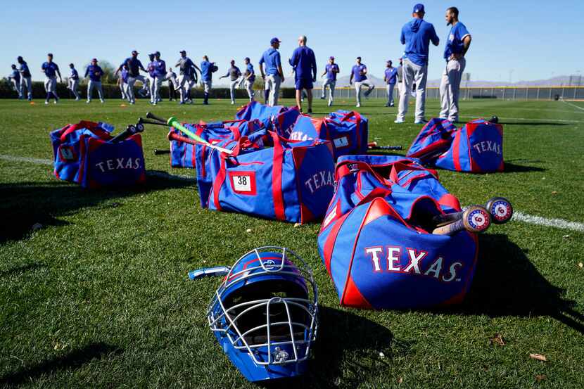 Texas Rangers players stretch during a spring training workout at the team's training...