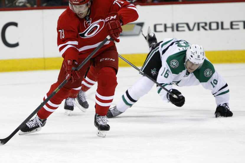 The Carolina Hurricanes' Brett Bellemore (73) moves the puck in front of a diving Ryan...