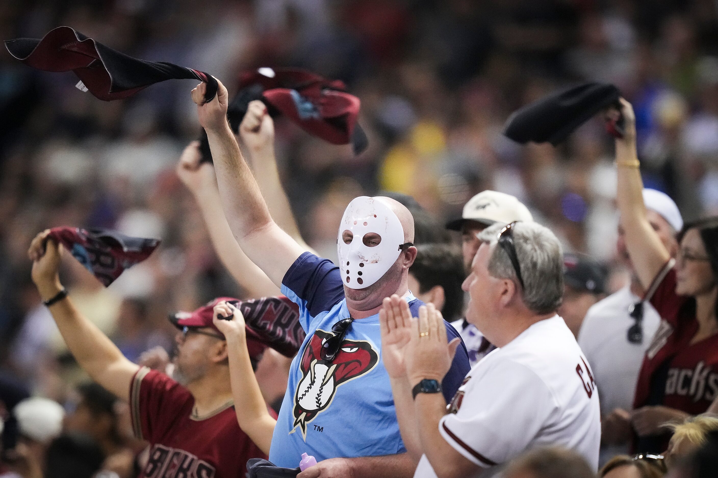 Arizona Diamondbacks fans dressed for Halloween wave towels during the eighth inning in Game...