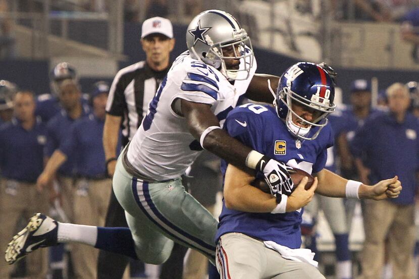 Dallas Cowboys defensive end George Selvie (99) sacks New York Giants quarterback Eli...