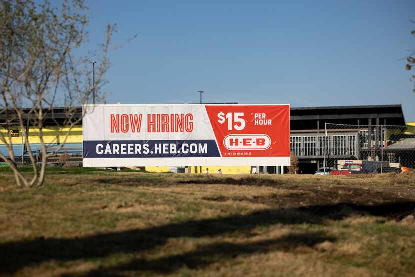 A hiring sign outside the H-E-B store under construction at 6001 Preston Road in Plano.