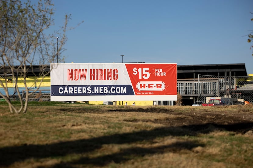 A hiring sign outside the new H-E-B under construction in Plano.