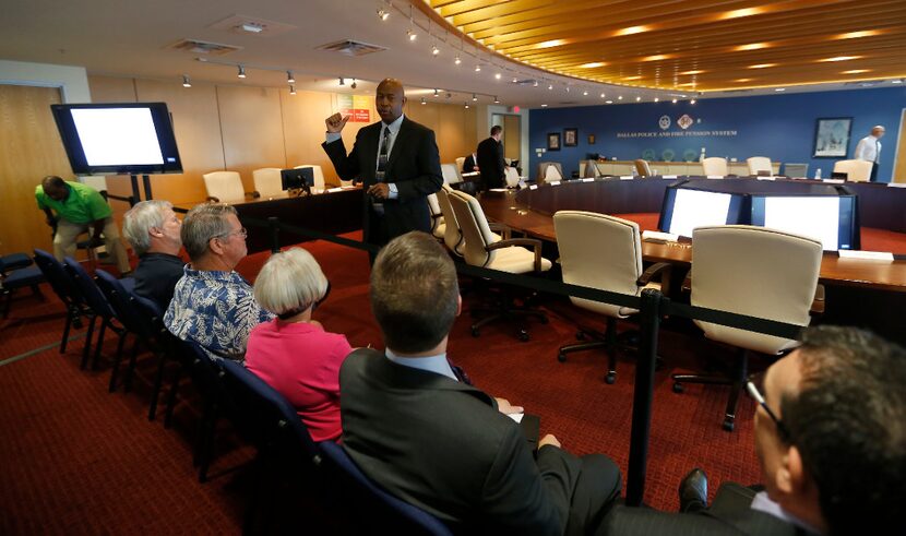 Friar talked with people in the audience during a break in the board meeting.