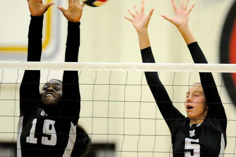 Bishop Lynch's Shalom Ifeanyichukwu (19) and Haley Puddy go up for a block.