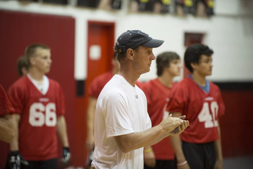 Fort Worth Christian offensive coordinator, Sam Harrell, works with players in the gymnasium...