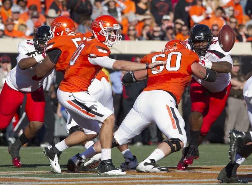 Nov 17, 2012; Stillwater OK, USA; Oklahoma State Cowboys quarterback Clint Chelf (10) pass...