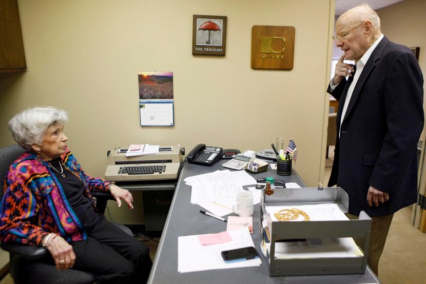 
Helen Hillbish (left) speaks with Taylor in the independent insurance agency’s downtown...