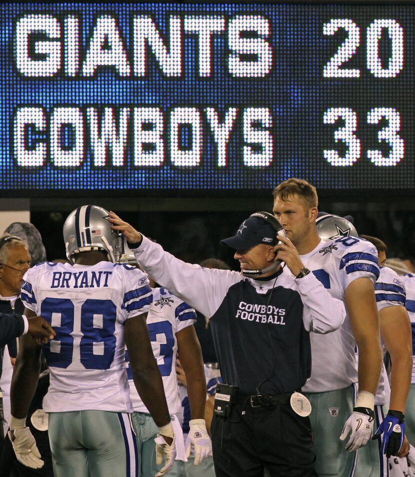 Head coach Jason Garrett slaps Dez Bryant on the helmet during the fourth quarter of the...