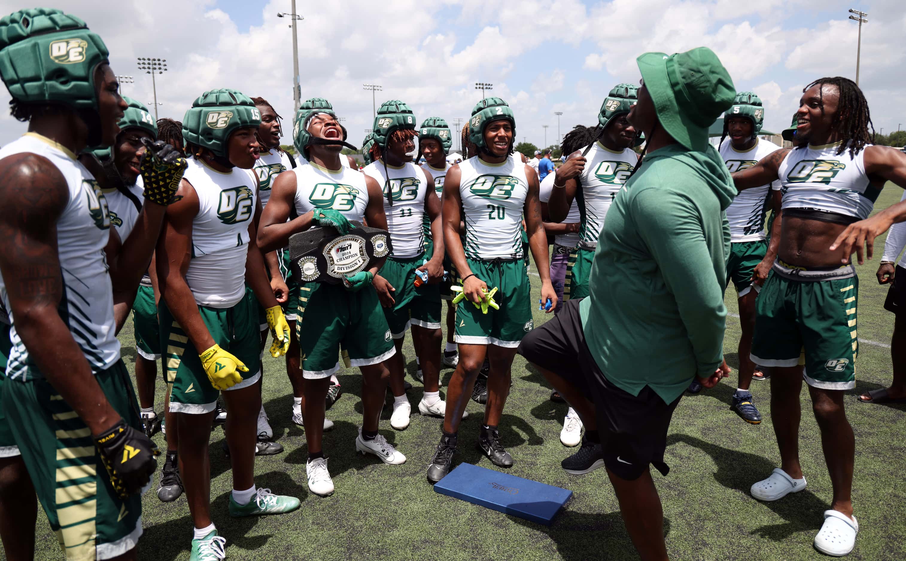 DeSoto head coach Claude Mathis, right, shares an inspiring message with his players...