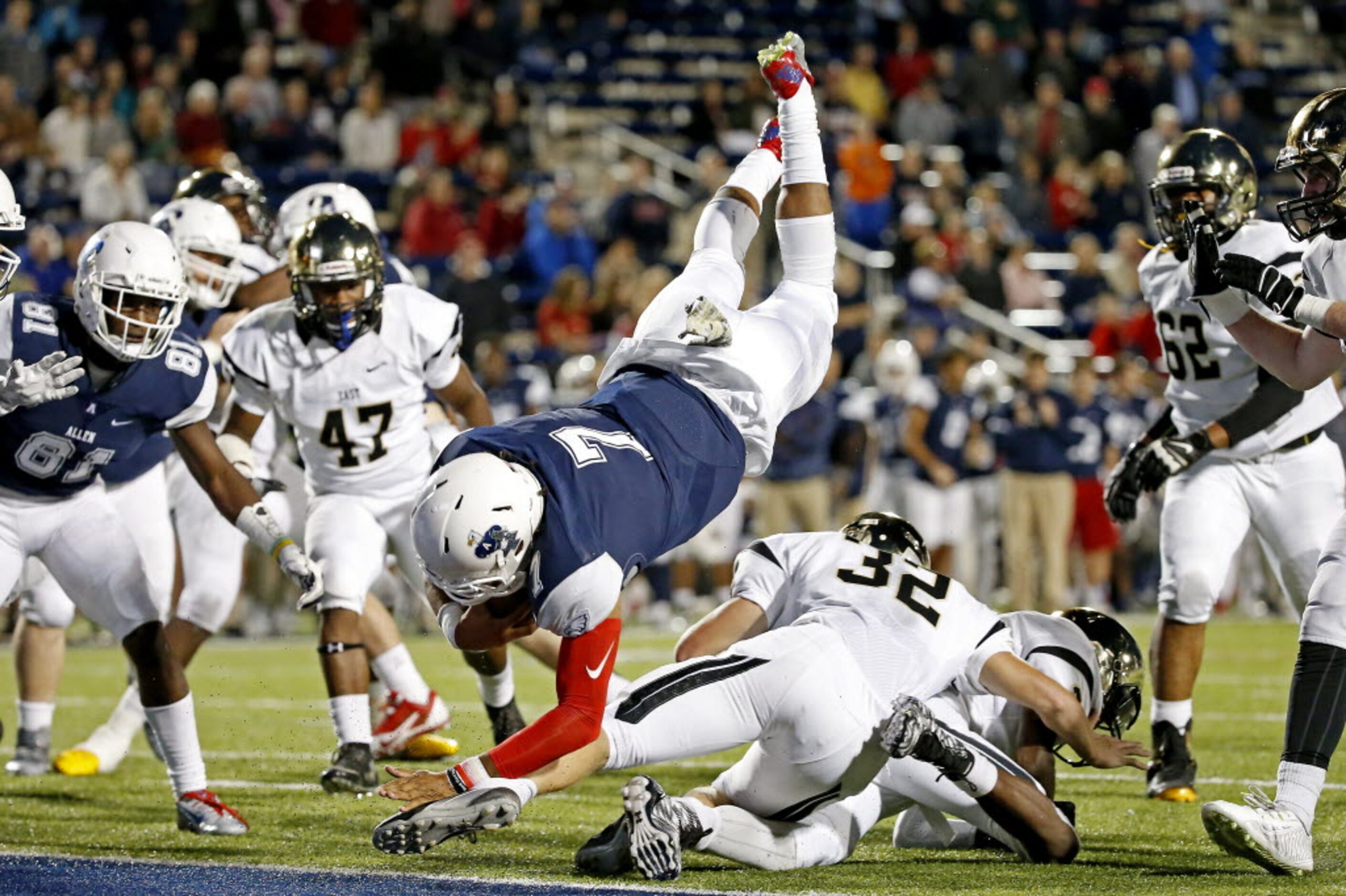 Allen's quarterback Seth Green (7) dives into the end zone over Plano East's Marcus Russell...