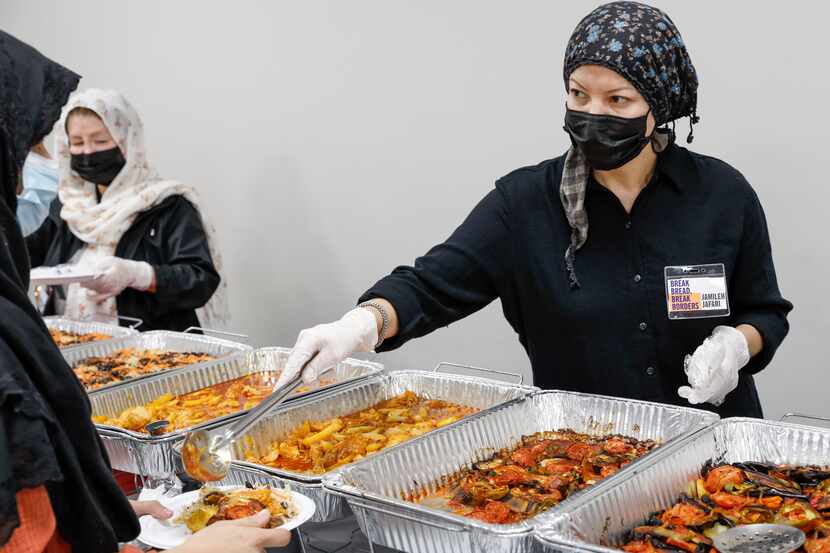 Jamileh Jafari serves food to Afghan evacuees at Catholic Charities Dallas on Dec. 22. Break...