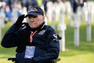 World War II and D-Day veteran Richard Ramsey salutes as he visits graves at the Normandy...