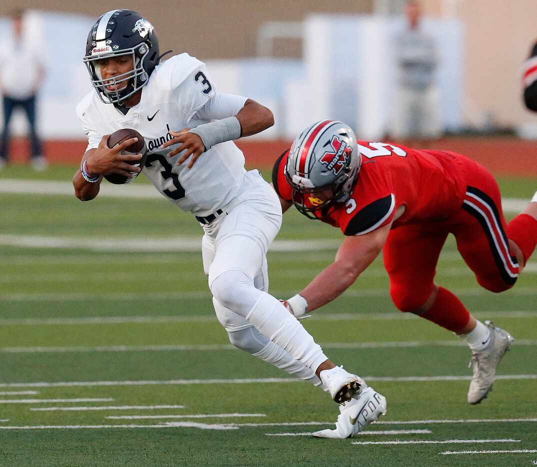 Flower Mound High School quarterback Nick Evers (3) escapes pressure from Flower Mound...
