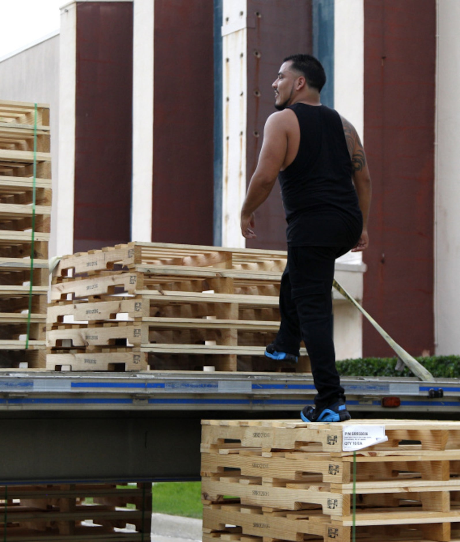 Yo Penado runs up a stack of pallets during the Second Annual Fair Park 5K Urban Dash...