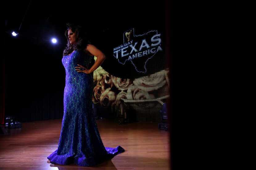 Sasha Frost poses in her evening gown during the Miss Gay Texas America preliminary round at...