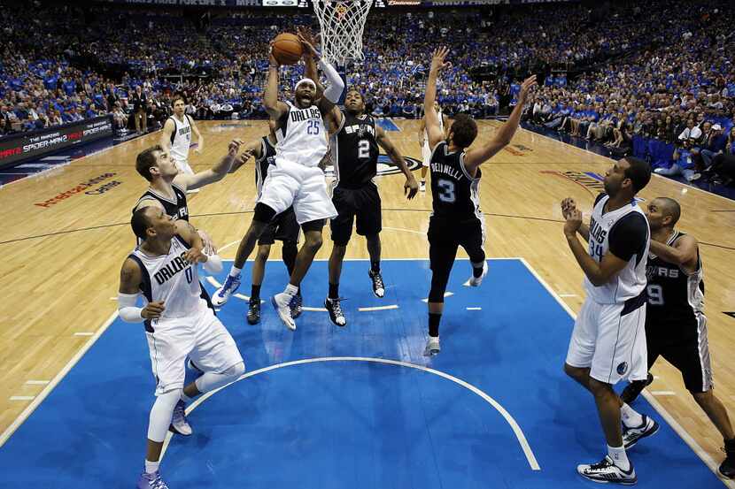 Dallas Mavericks guard Vince Carter (25) puts up a second half shot as he is guarded by the...