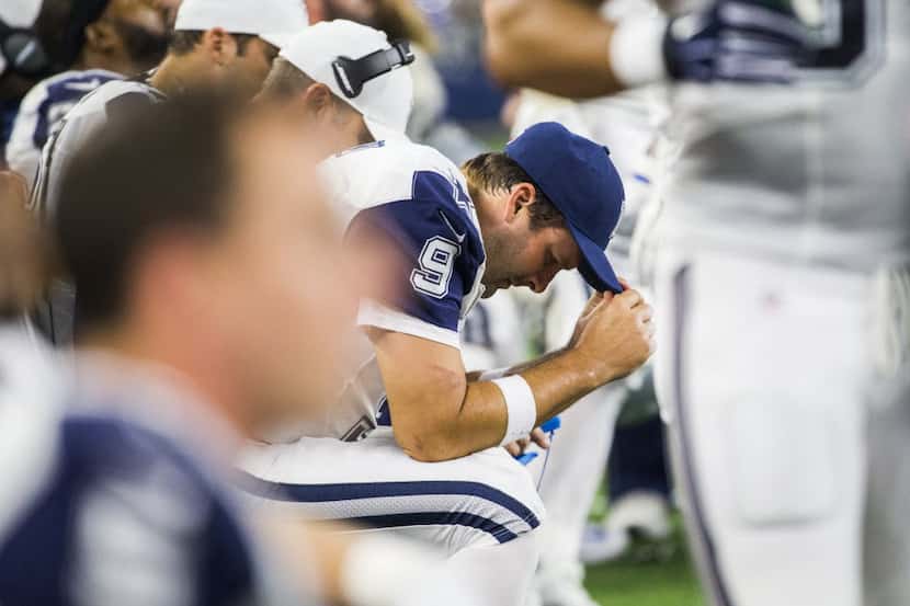 Dallas Cowboys quarterback Tony Romo (9) takes a moment on the sideline during the second...