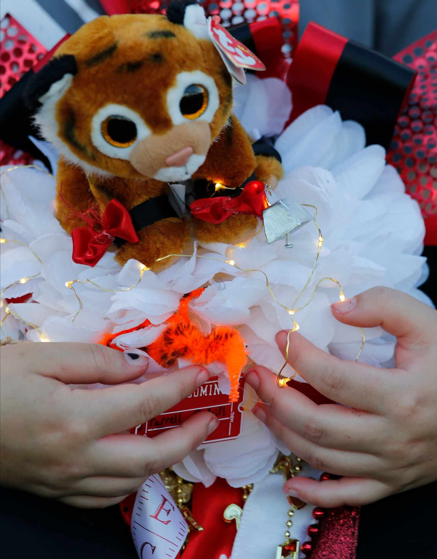 A Terrell fans holds a homecoming mum during the first half of a high school football game...