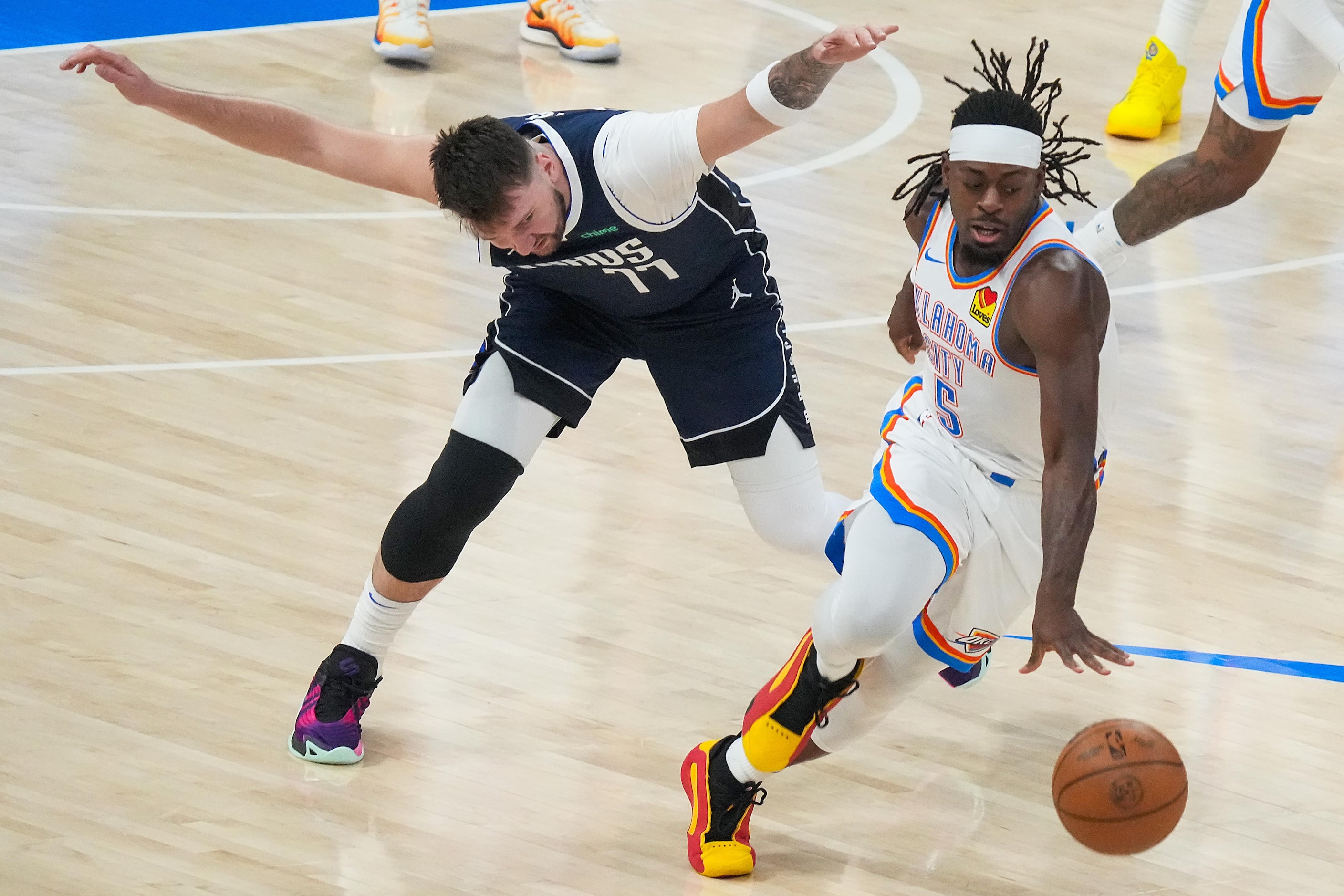 Oklahoma City Thunder guard Luguentz Dort (5) steals the ball from Dallas Mavericks guard...