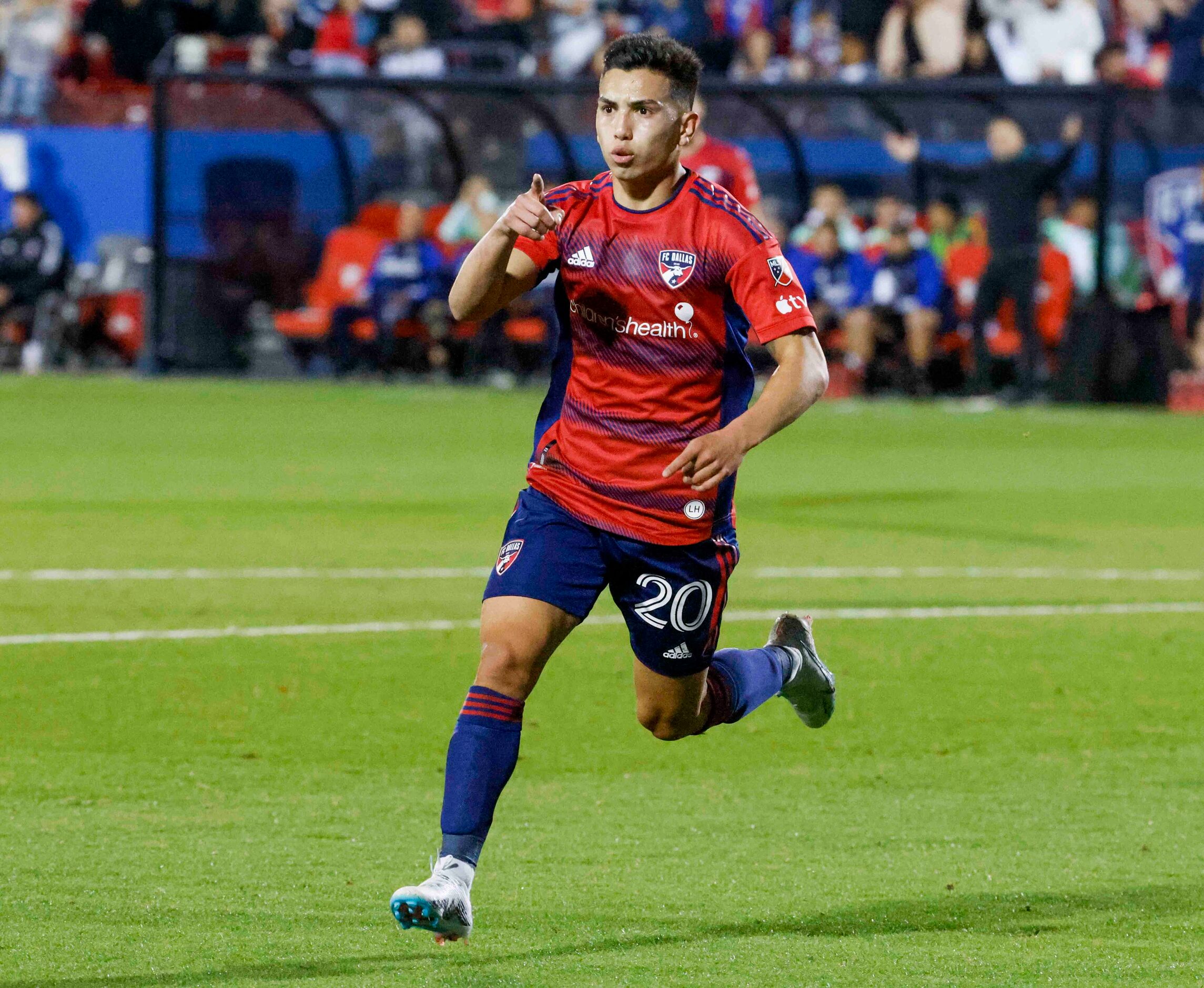 FC Dallas forward Alan Velasco (20) points towards forward Paul Arriola as he celebrates a...