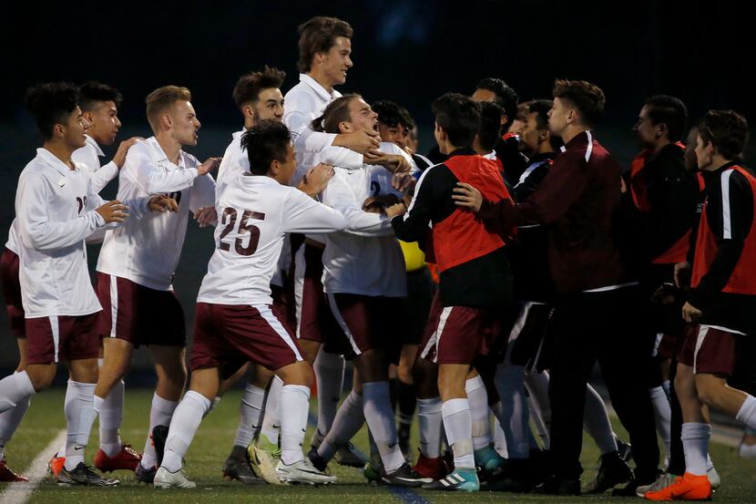 Rowlett's Carson Prestridge (2) is congratulated by his teammates after scoring a goal on a...