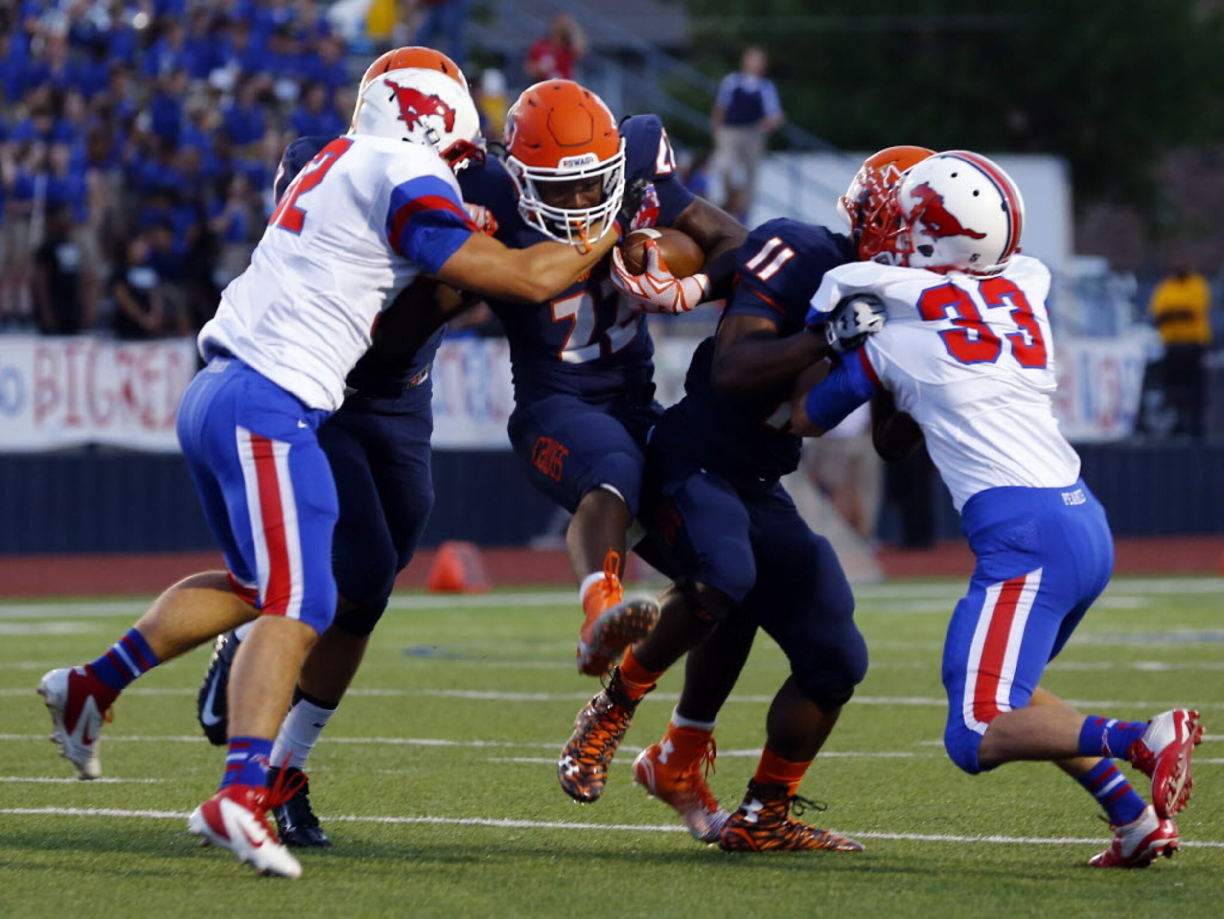 TXHSFB McKinney North running back KJ Hart (22) tries to break away from Richardson Pearce...