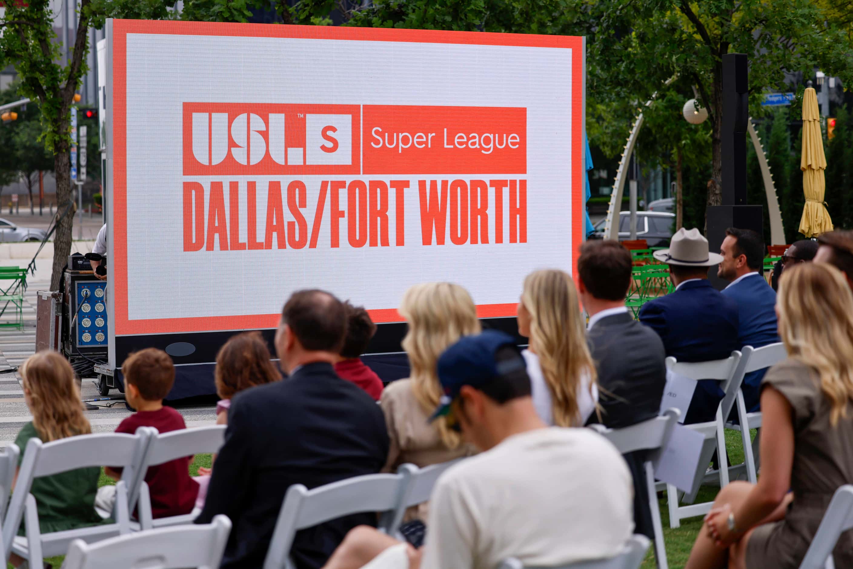 People listen as USL Super League President Amanda Vandervort speaks before the unveiling of...