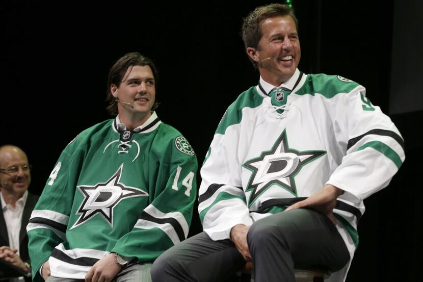 Former Dallas Stars Mike Modano, right, and current left wing Jamie Benn smile as they wear...