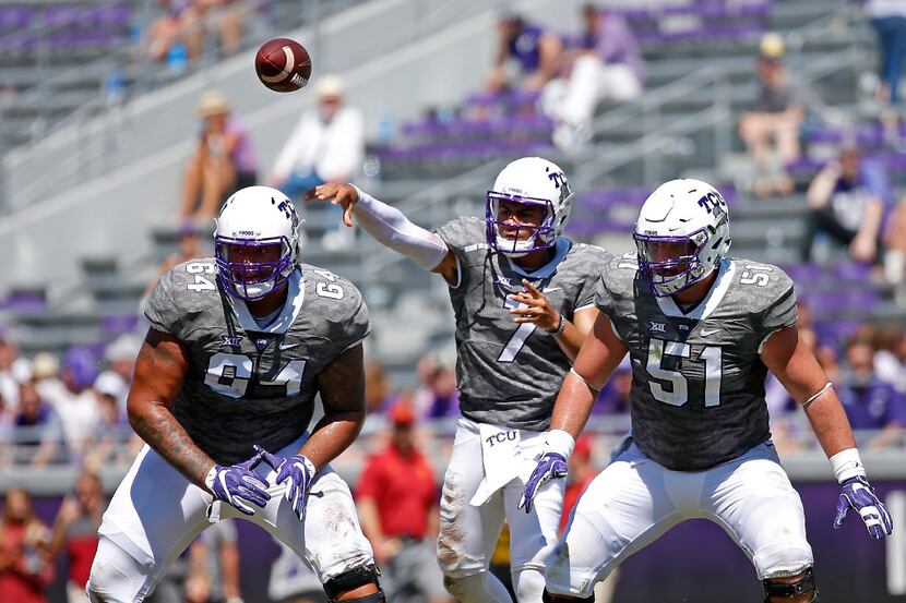 FILE - TCU quarterback Kenny Hill (7) throws the ball downfield over center Austin...