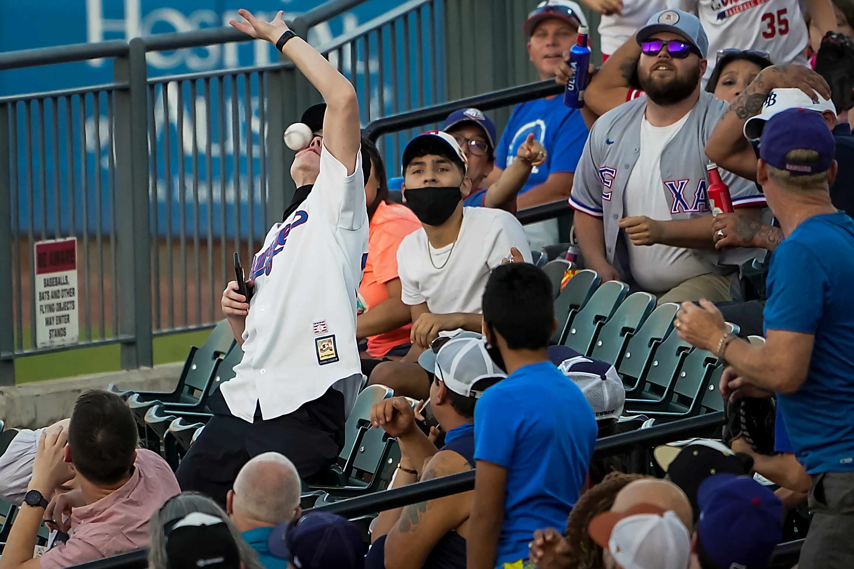 Fan Nolan Phillips is hit in the face as he tries to catch a foul ball of the bat of Round...