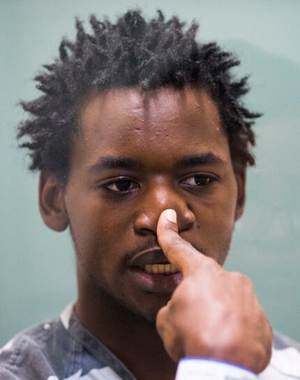 Remon Hendrix, 23, touches his nose, recreating a moment in a recent altercation, as he...