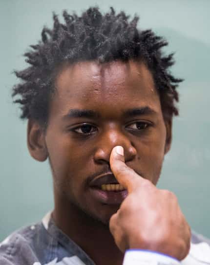 Remon Hendrix, 23, touches his nose, re-creating what he says happened to spark the DART...