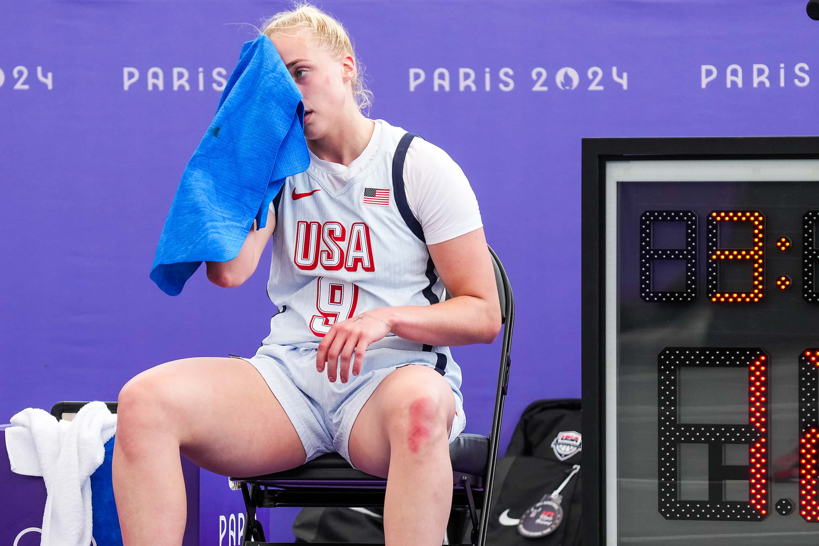 Hailey van Lith of the United States (9) towels off during timeout in women’s 3x3 basketball...