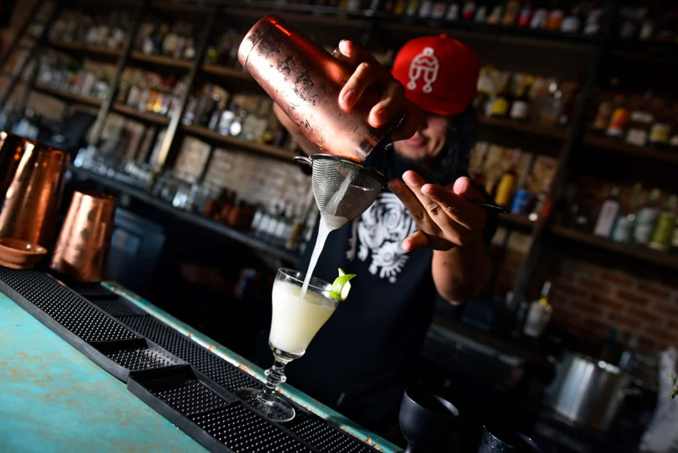 Bar manager Christian Armando Guillen prepares a "Cojones! My Tongue!" cocktail from Ruins...