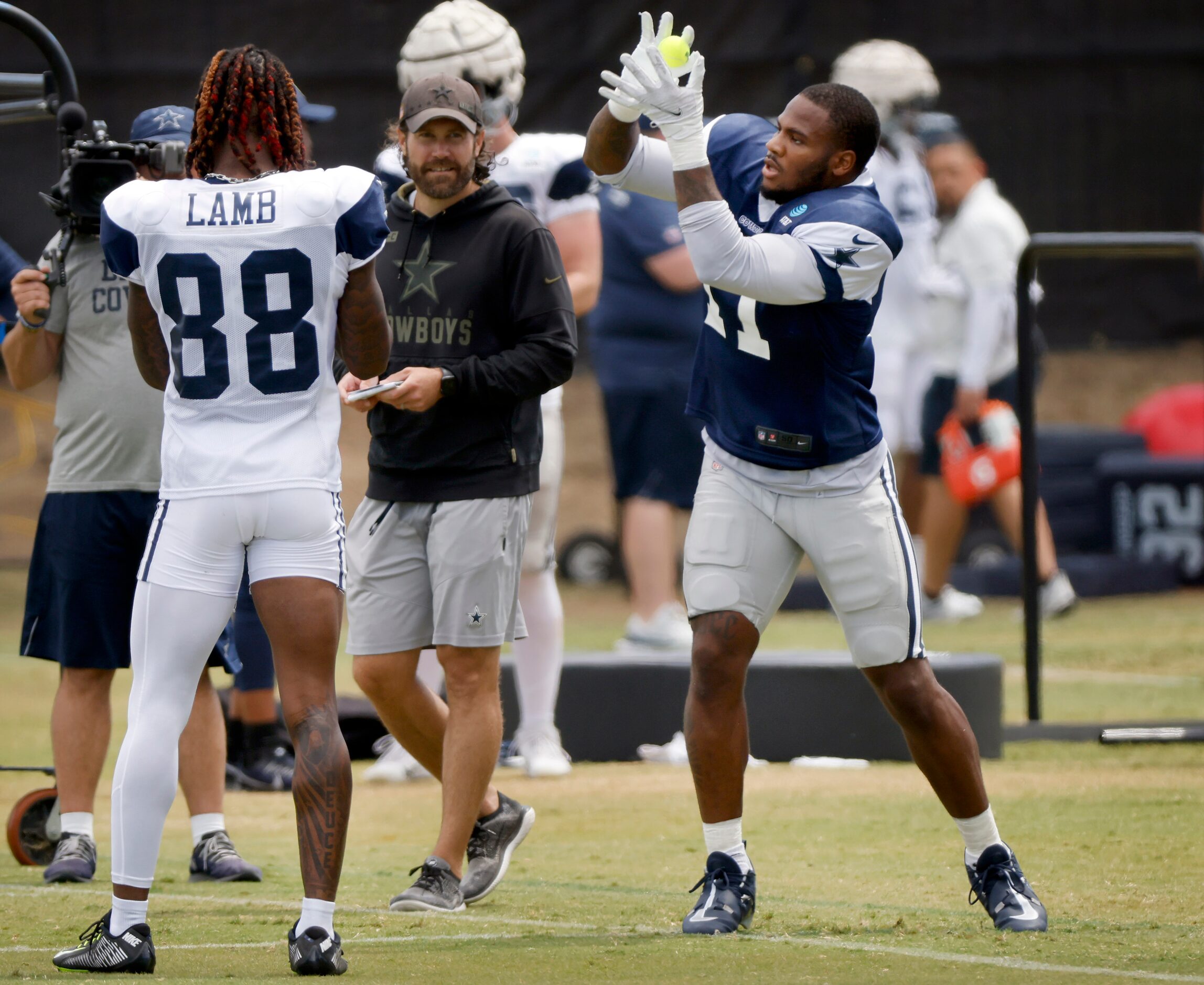 Dallas Cowboys outside linebacker Micah Parsons (11) catches tennis balls during training...