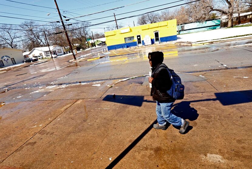 
Artis Frank walks home after his last stop on DART. He walks and takes the DART bus and...