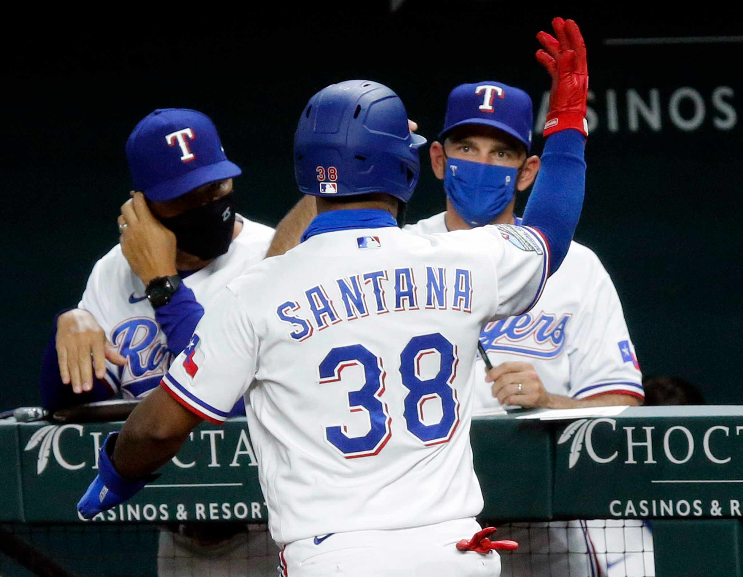 Texas Rangers designated hitter Danny Santana (38) is congratulated by manager Chris...