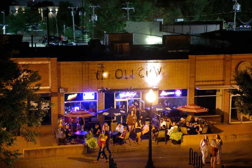 Patrons at The Old Crow have drinks on the patio on Aug. 24, 2019. Sara Hudson was on her...