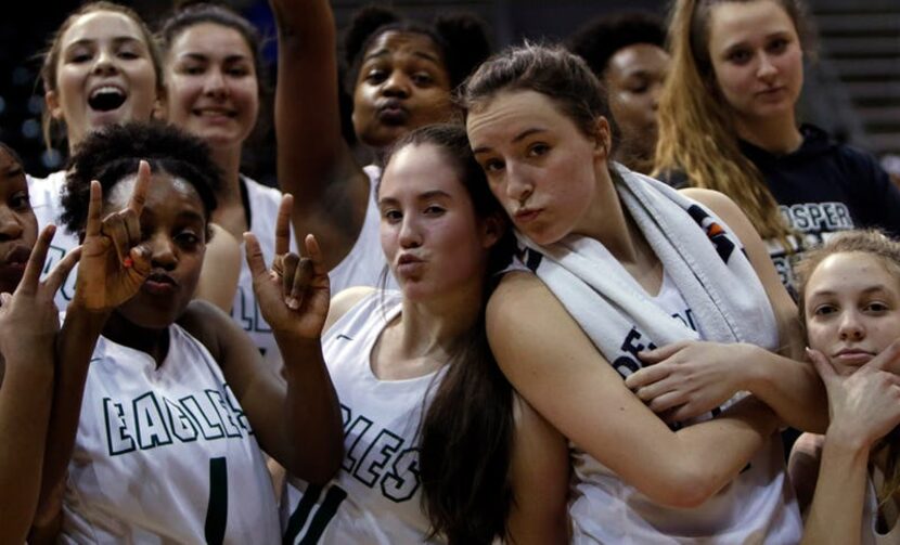 Prosper players strike an impromptu pose for the camera while celebrating at mid court...