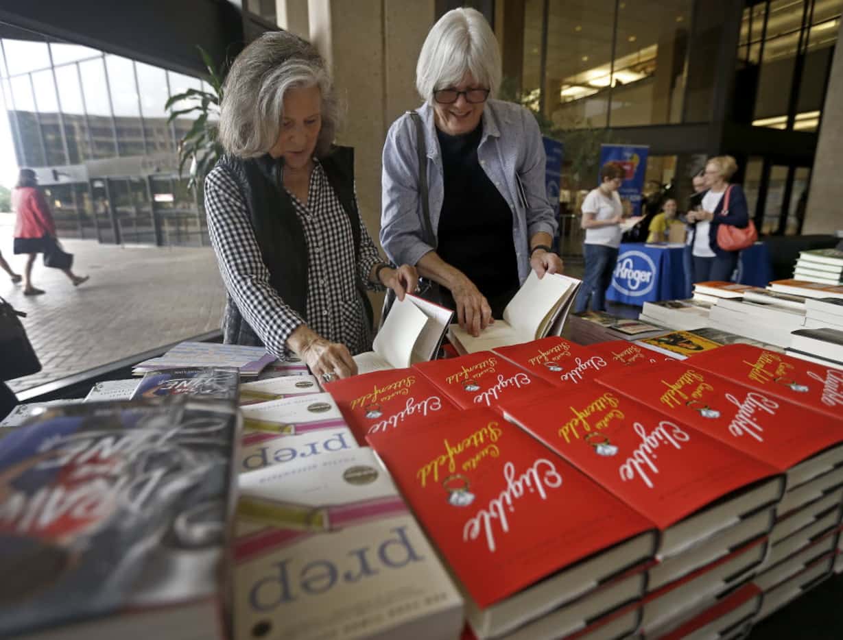 Joyce Dorsey (left) and her friend Jen Carrick take a look at books at the the Wild...