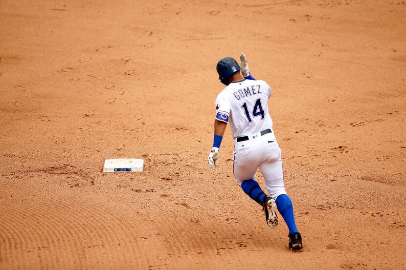 Texas Rangers Carlos Gomez rounds second base after hitting a two-run homer to left against...
