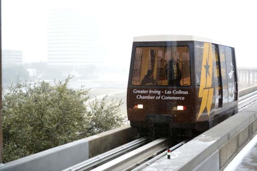 The Las Colinas Area Personal Transit System  tram arrives at Tower 909 Station in Las Colinas.