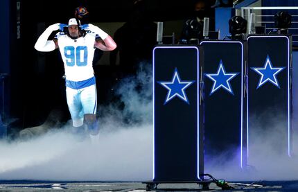 FILE - Cowboys defensive end DeMarcus Lawrence (90) is introduced before a game against the...