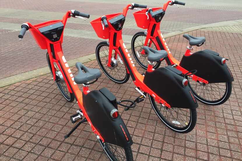 JUMP rechargeable electric bikes sit on the corner of South Harwood and Marilla streets near...
