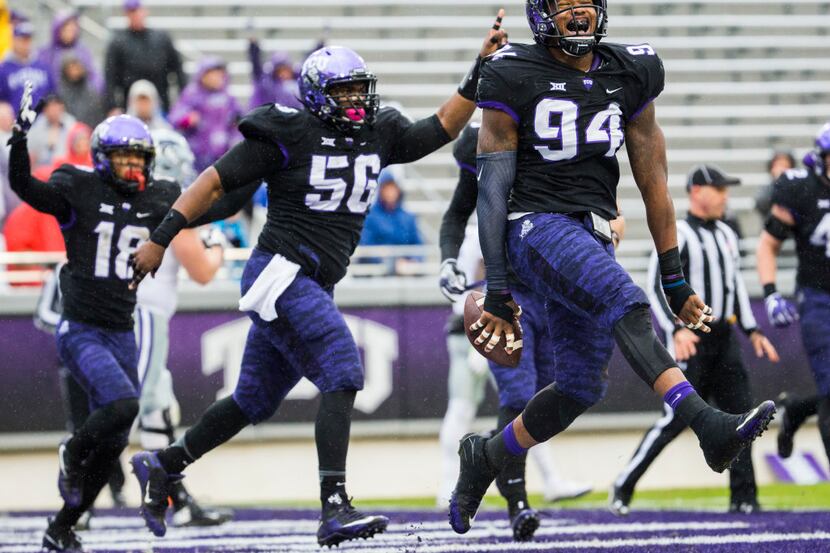 TCU Horned Frogs defensive end Josh Carraway (94) celebrates after recovering a fumble and...