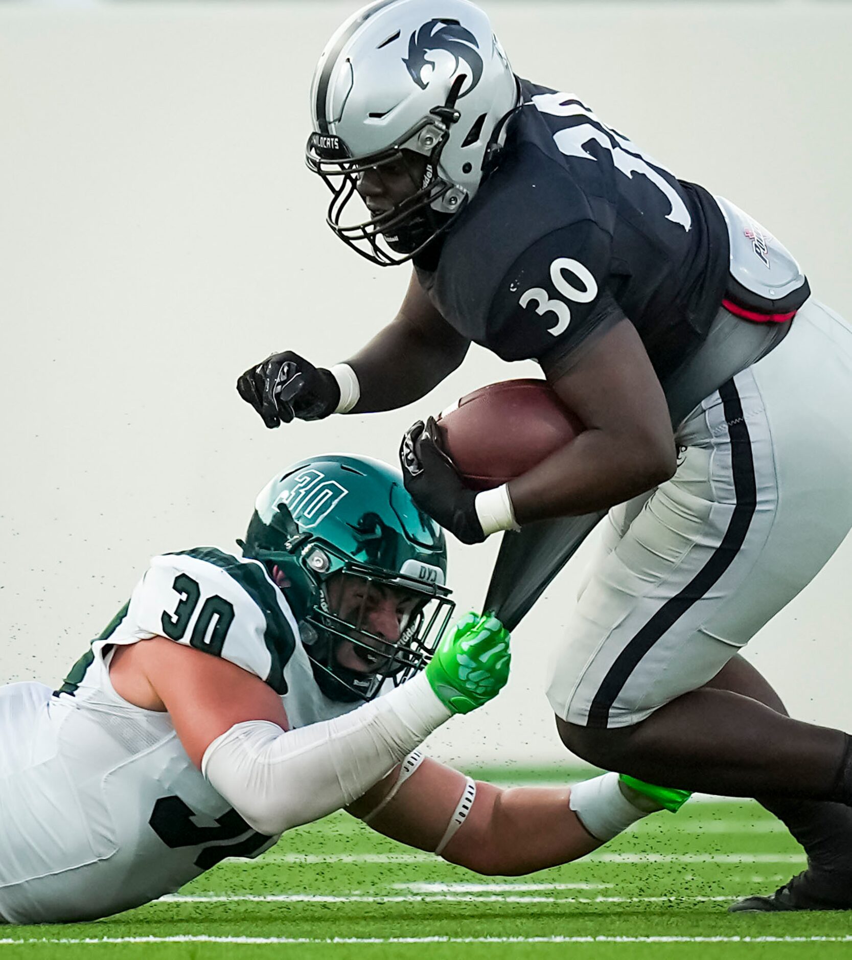 Denton Guyer running back Ahmed Yussuf (30) is pulled down by Prosper linebacker Davis...