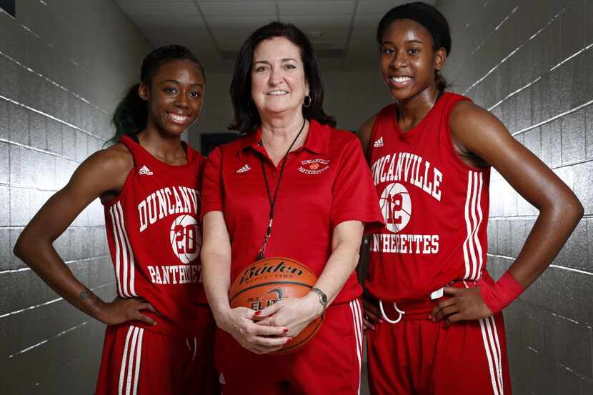 Tasia Foman (20), Head Coach Cathy Self-Morgan, and Ariel Atkins (12) pose for a photo at...