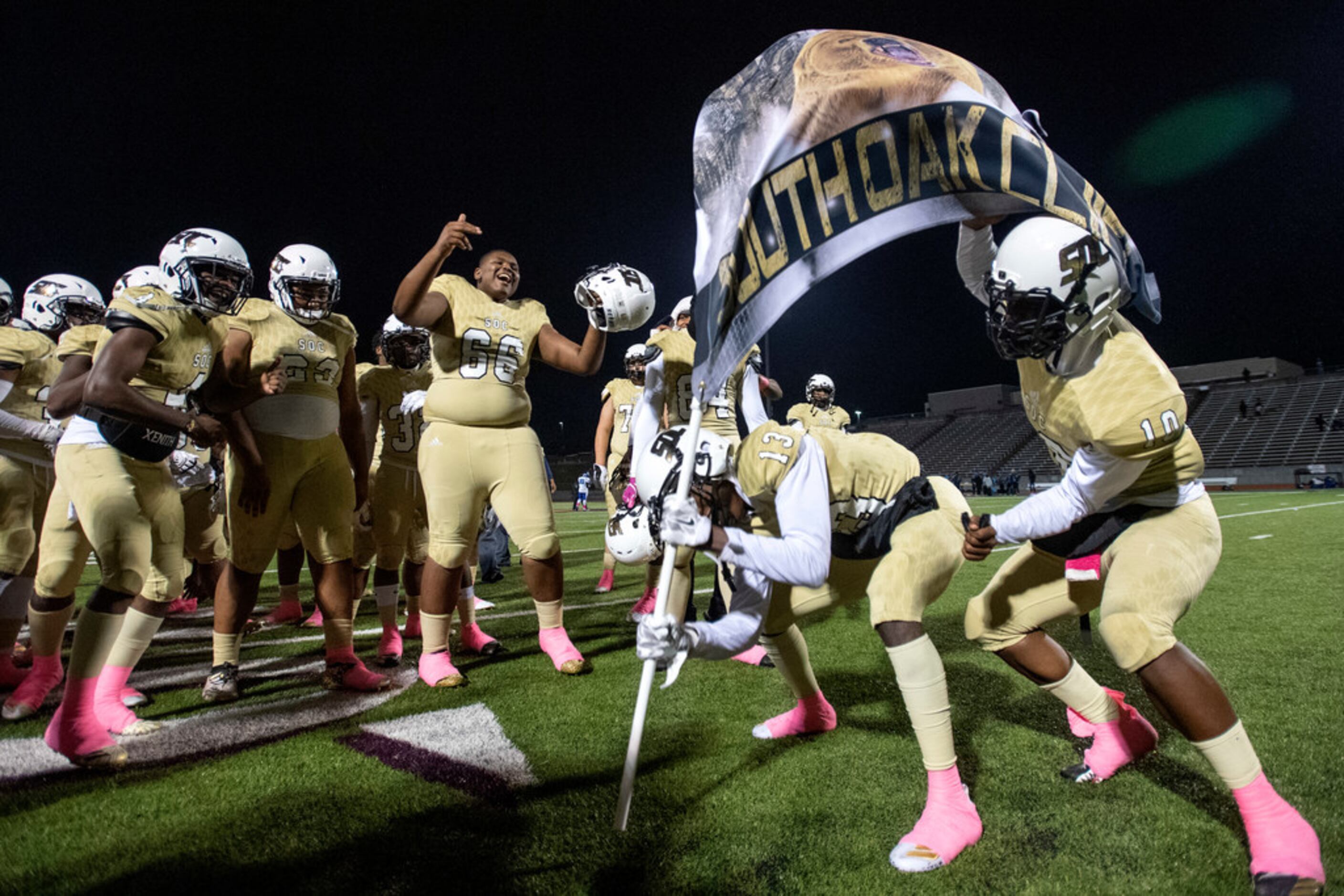 South Oak Cliff players cheers as junior wide receiver Justyn Harrison (13) and junior...