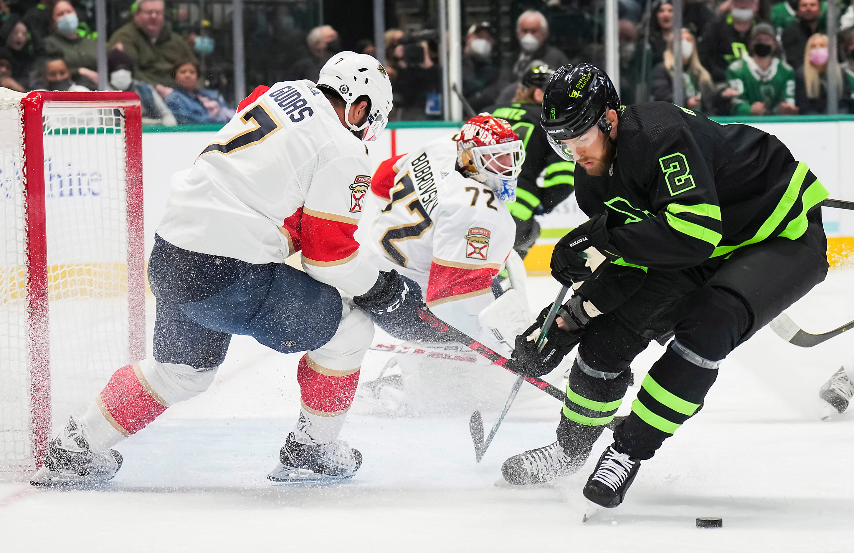 Dallas Stars defenseman Jani Hakanpaa (2) fights for the puck with Florida Panthers...