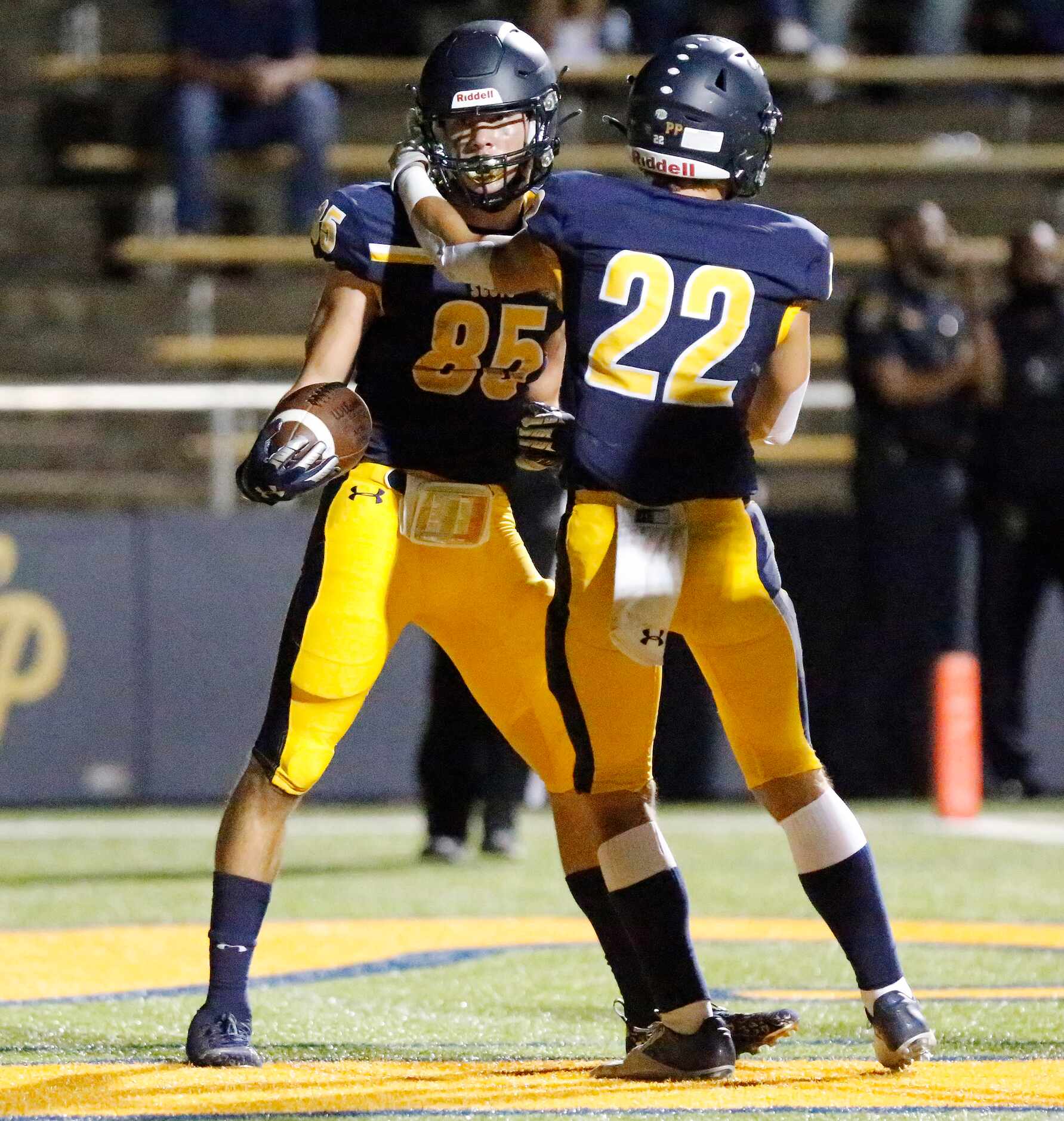 Highland Park High School wide receiver Jackson Heis (85) is congratulated by Highland Park...